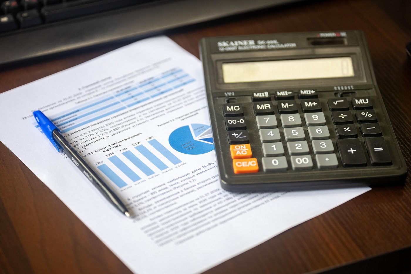 Calculator beside financial report